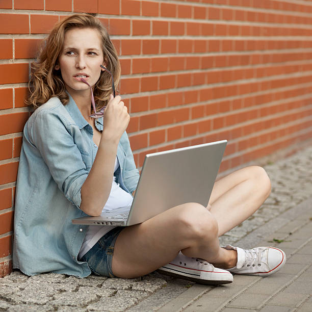 istock Upset student working with laptop, thinking of something 490364368