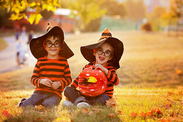 dois garotos no parque com fantasias de halloween - child autumn nature human face - fotografias e filmes do acervo