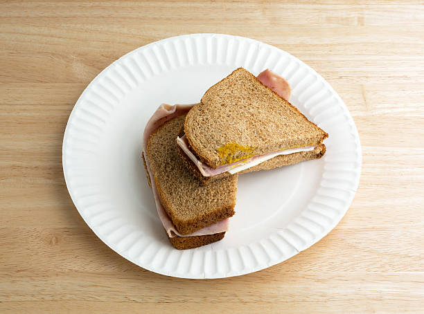 istock Ham and cheese sandwich on a white paper plate 490366302
