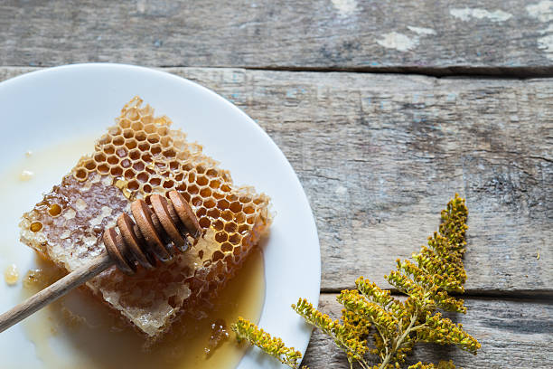 istock Honey with honeycomb on wooden table 490367032