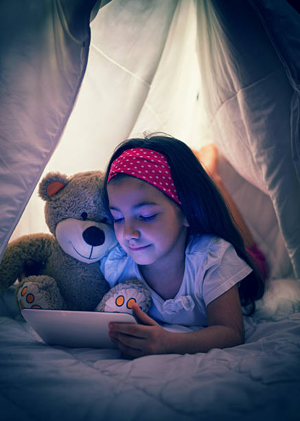 istock Little Girl Using Digital Tablet in Bed 490371634