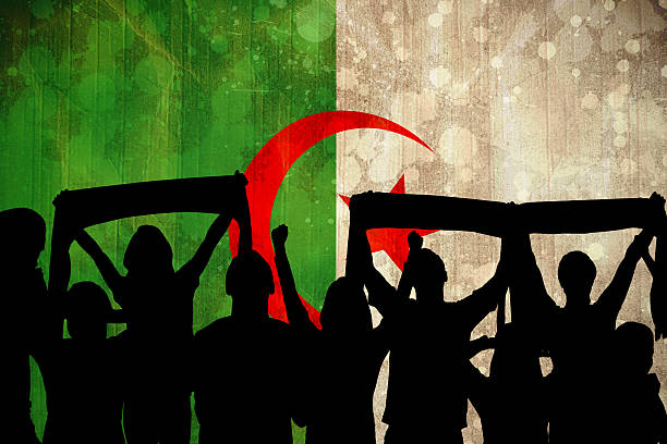 Silhouettes of football supporters Silhouettes of football supporters against algeria flag in grunge effect algeria soccer stock pictures, royalty-free photos & images