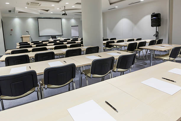 istock Modern lecture hall with papers and pens on tables 490377069