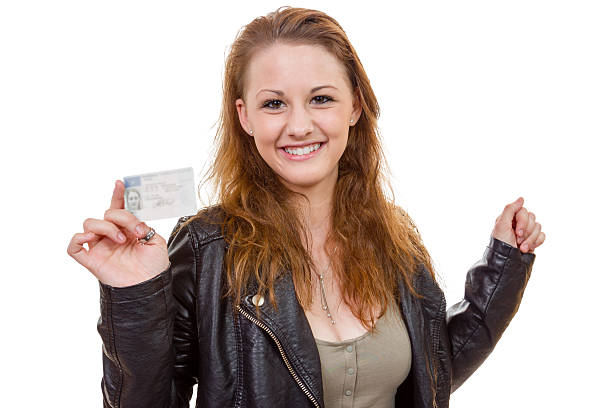istock Young woman showing her driver's license 490378839
