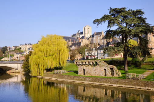 The river Sarthe and weeping willow and the ruins of old fortification at Le Mans of the Pays de la Loire region in north-western France