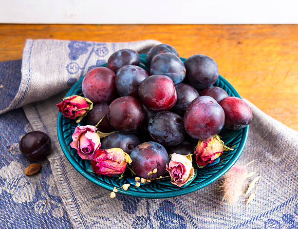 istock Purple plums in a green plate 490390396