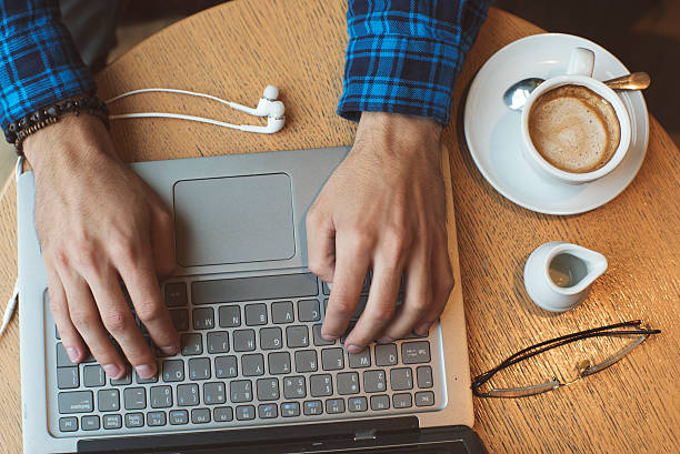 istock Young hipster man working on laptop in coffee shop 490394382