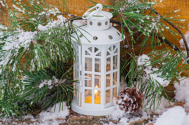 istock Decorative lantern burning in the snow with a conifer branch 490394774
