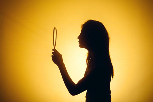 istock Silhouette Of A Woman Looking Into Handheld Mirror 490396534