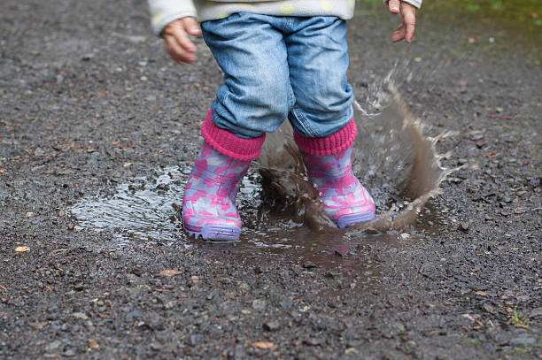 istock Girl jumps into a puddle 490397222