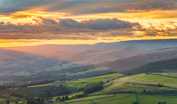 istock Stunning Ray Of Orange Light Shining On Peak District. 490402734