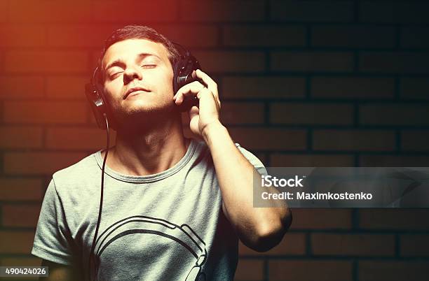 Portrait Of A Handsome Young Man Listening To Music Stock Photo - Download Image Now