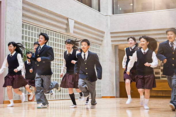 istock Japanese students running in the school corridor 490425092