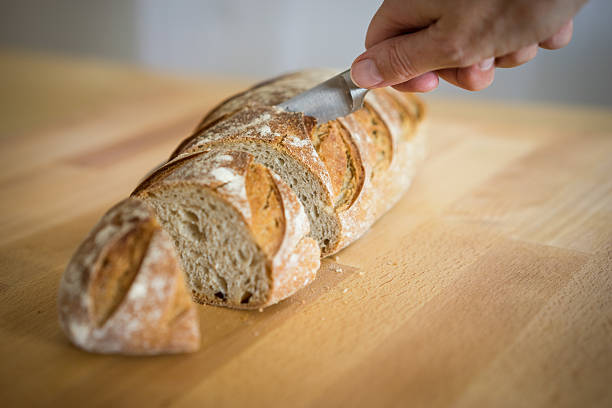 istock Fresh bread from market being sliced 490426926
