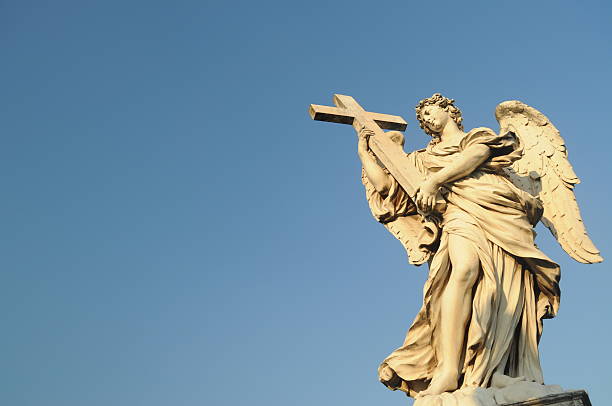 istock Angel statue holding cross 490430158