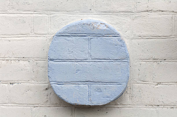 istock white brick wall with blue circle in the center closeup 490430608