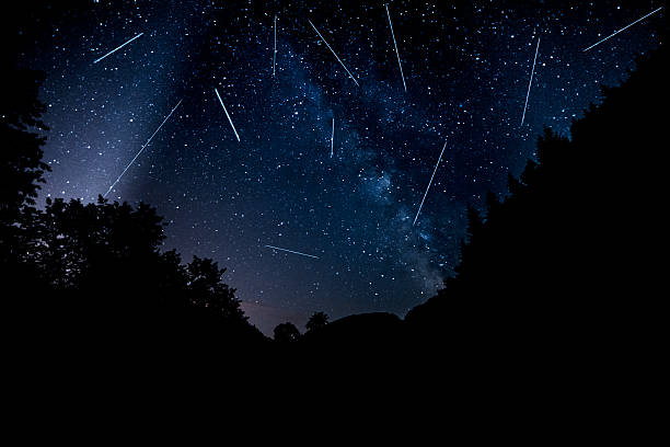 perseids in night time night view in the forest with perseids on sky and the milky way. meteorite photos stock pictures, royalty-free photos & images