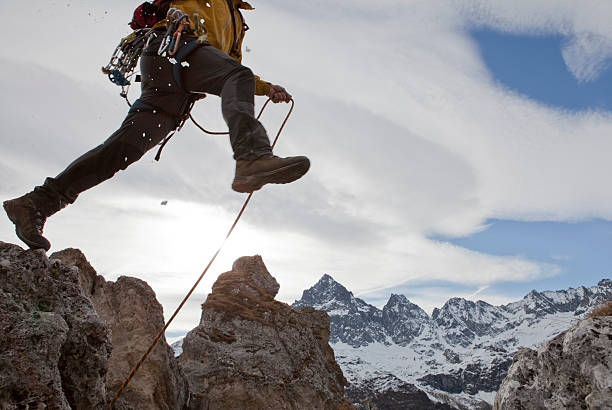 istock Lower torso of mountaineer in mid-air jump 490433280