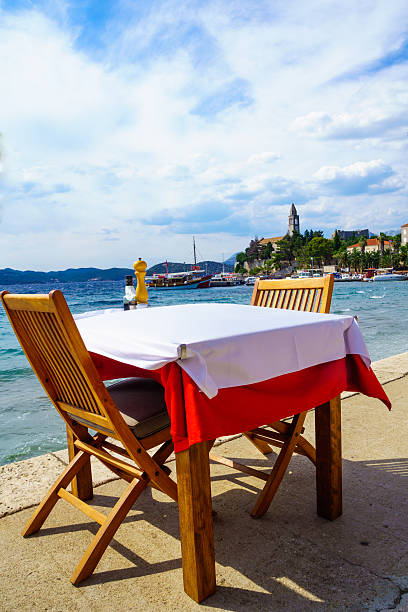 Lopud Beach and Port View of the fishing port and the beach, with cafes, boats, in the village Lopud, Lopud Island, one of the Elaphiti Islands, Croatia dubrovnik lopud stock pictures, royalty-free photos & images