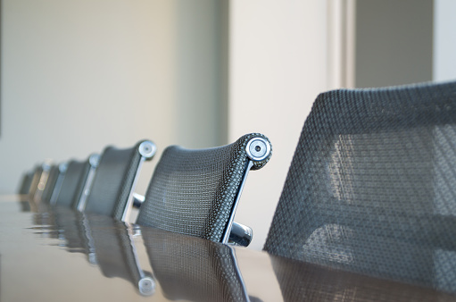 Modern conference room chairs and table shot with a shallow depth of field.
