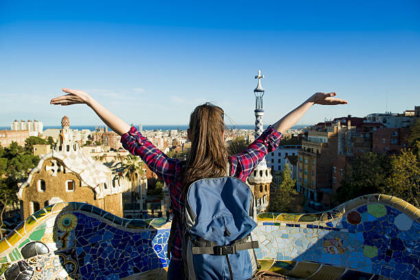 Woman tourist Rear view of young female tourist enjoying the view in Parc Guell in Barcelona, Spain. student travel stock pictures, royalty-free photos & images