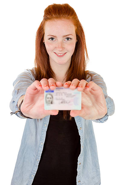 istock Young woman showing her driver's license 490452569