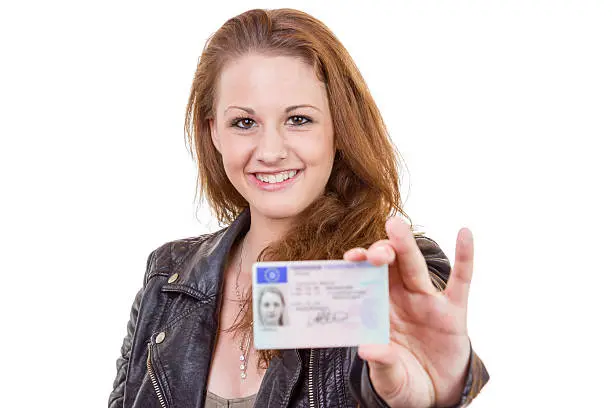 Photo of Young woman showing her driver's license
