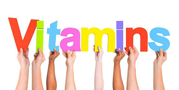 istock Diverse Hands Holding The Word Vitamins 490453681