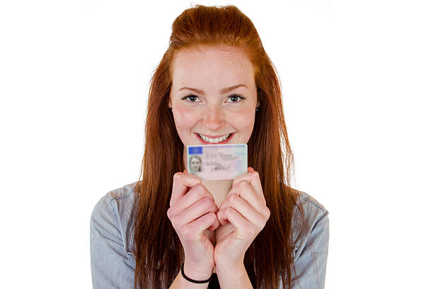 istock Young woman showing her driver's license 490455413