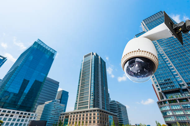 istock CCTV Camera or surveillance oeprating with building in backgroun 490456357