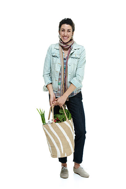 istock Cheerful woman holding vegetable bag 490457219