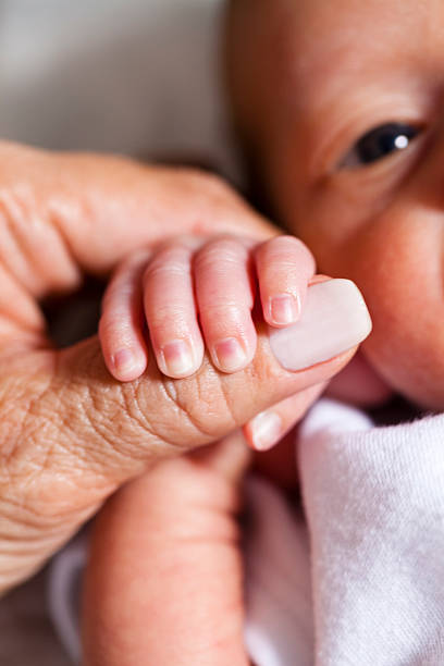 istock Newborn Holding Mother's Hand 490457873