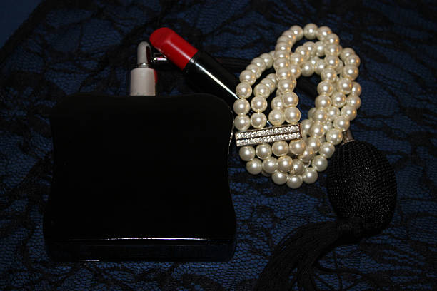 istock French Perfume Bottle with Pearls and Red Lipstick 490473496