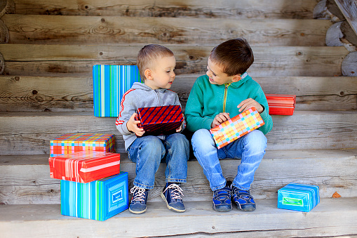 two little brothers lovingly exchange gifts