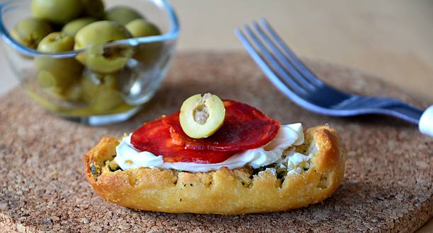 istock Italian bruschetta bread with salami and mozzarella on a plate 490474436