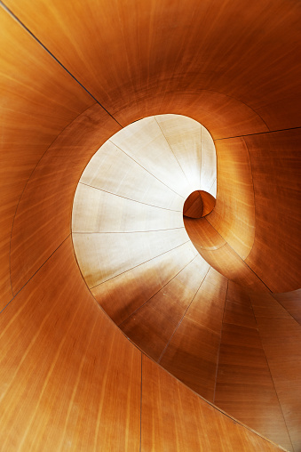 High empty wooden spiral staircase
