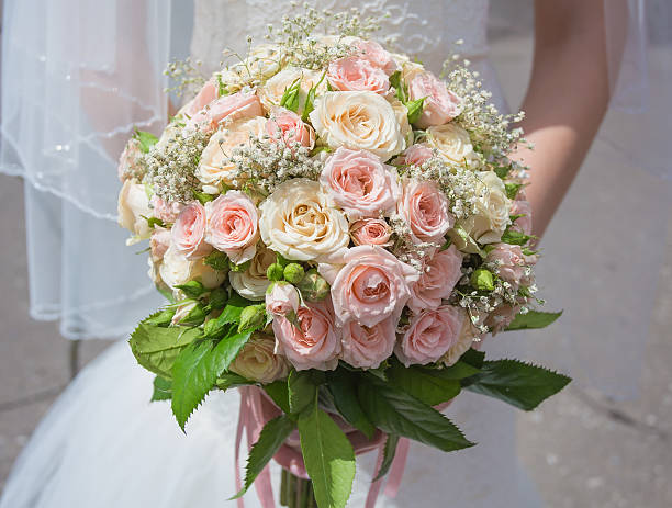 istock Hands and rings on wedding bouquet 490482858