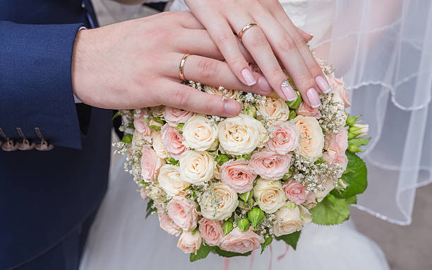 istock Hands and rings on wedding bouquet 490482878