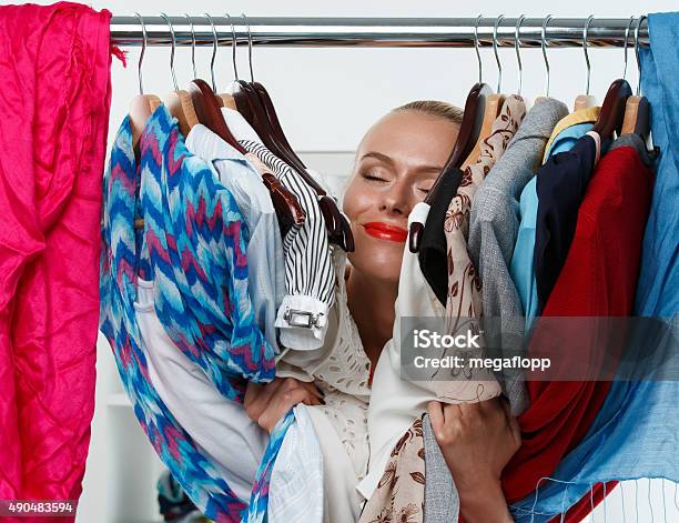 Beautiful Smiling Blonde Woman Standing Inside Wardrobe Rack Stock Photo - Download Image Now