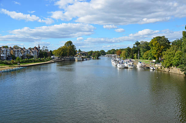 Molesey River Thames the River Thames at East Molesey and Hampton Court in Greater London hampton court stock pictures, royalty-free photos & images