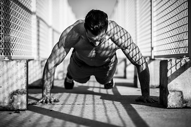 行う腕立て伏せ - low angle view macho men urban scene ストックフォトと画像