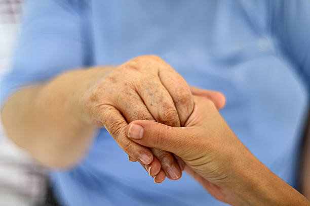 istock Senior And Young Woman Holding Hands 490487016
