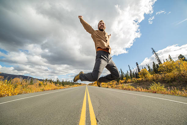 istock Young man jumping in middle of road 490487868