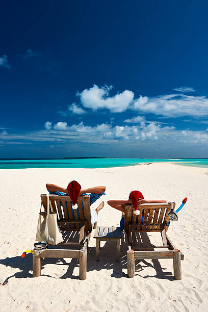 istock Couple relax on a beach at christmas 490503120