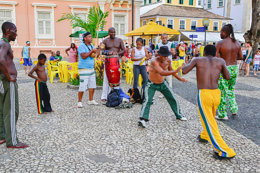 Salvador, Brasil - January 10, 2012: A group of people playing Capoeira. Capoeira is a Brazilian martial art that combines elements of dance, acrobatics and music, and is sometimes referred to as a game. (Salvador - BA)