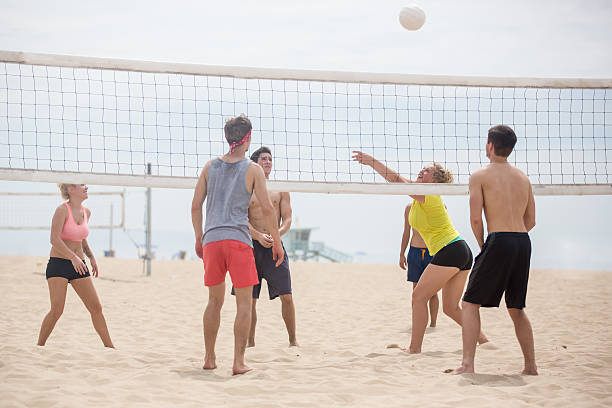 istock Group of friends playing beach volleyball 490505754