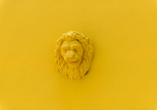 Stucco head of a lion on the wall