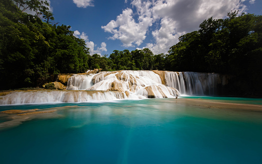 Wide angle of Agua Azul and its clear and pristine waters. Agua Azul is in the Mexican State of Chiapas. A series of waterfalls with many cataracts following one another leaving large limestone deposits.