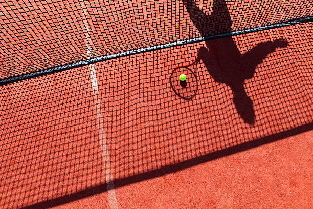 shadow of a tennis player behind the net