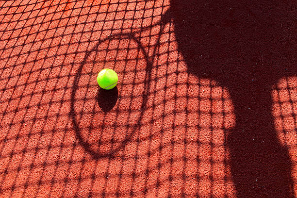 istock ball on the shadow of a tennis racket 490512854